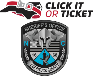 Click it or Ticket campaign logo, Red seat belt around map of North Carolina. Also the Currituck County Sheriff's Logo.