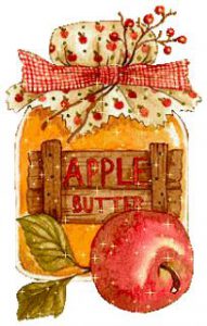Apple Butter jar with a flower cloth cover and apple leaning up against the jar.