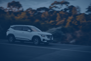 Car driving down a country road.