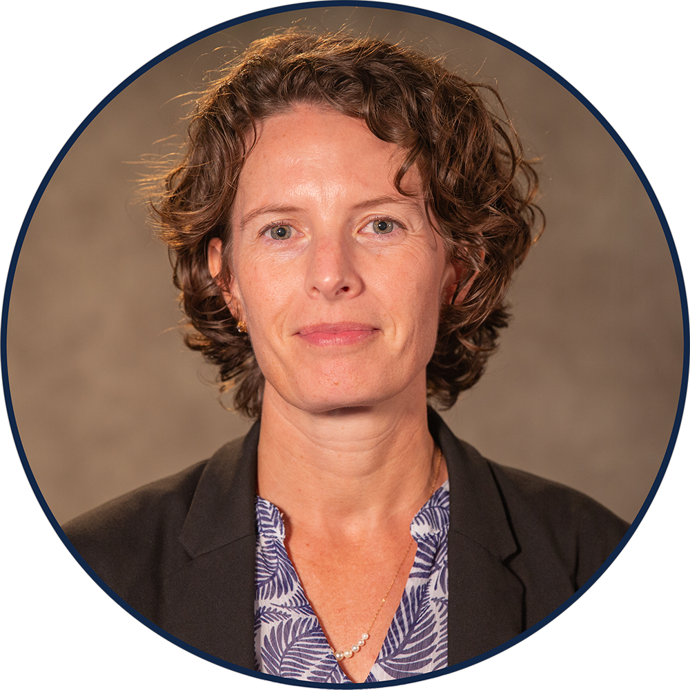Currituck County Manager head shot with dark curly hair.