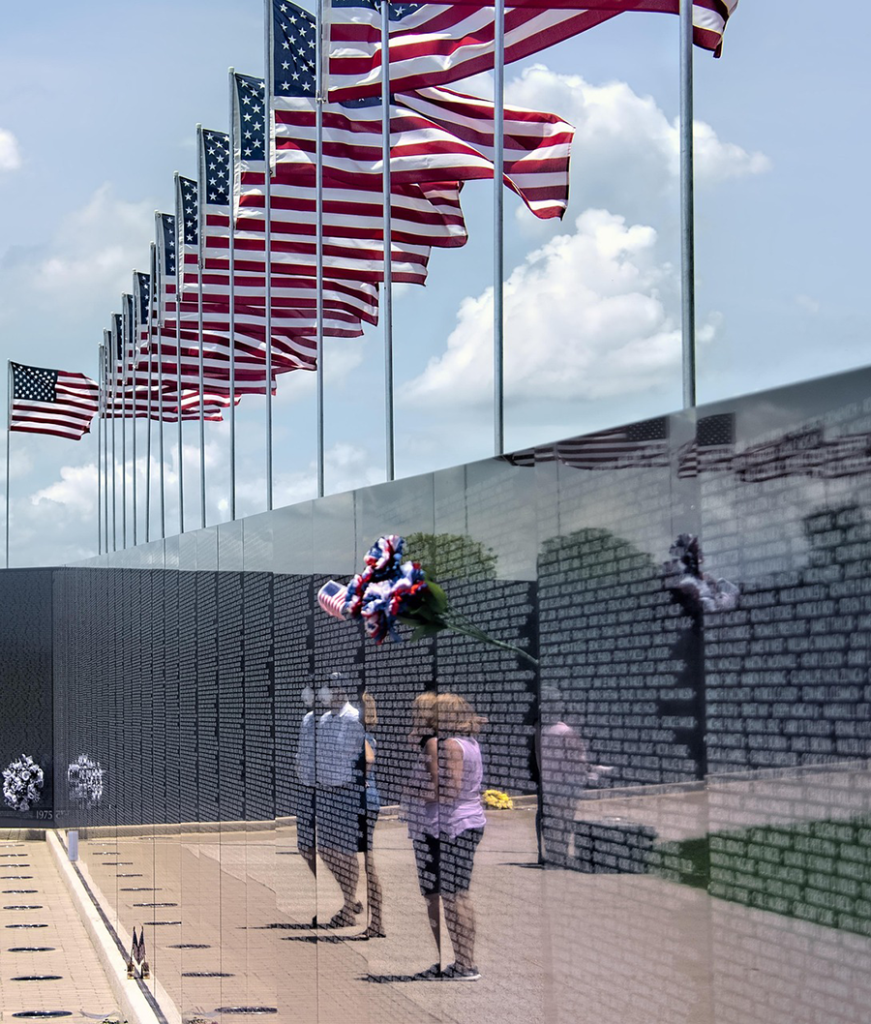 Flags flying over the Vietnam Memorial Wall.