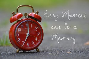 Red alarm clock with words "Every Moment can be a memory. "with