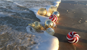 Christmas Ornaments in the surf at the beach.