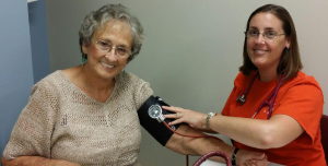 Senior women getting her blood pressure taken by a female health care worker.