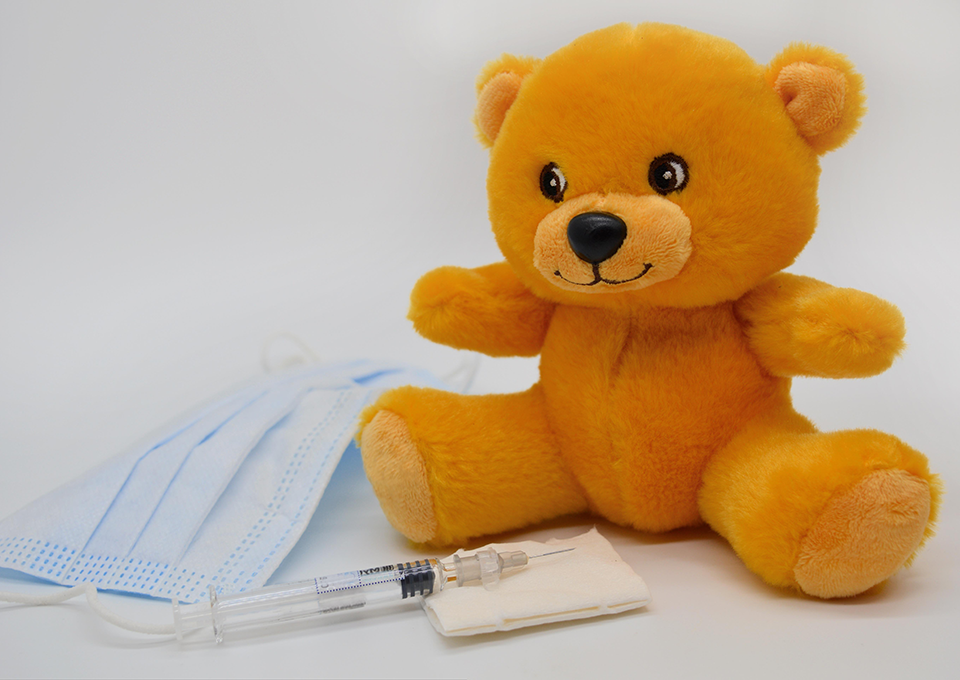 Stuff orange bear, needle, mask and guaze.