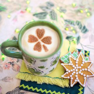 Irish coffee mug with creamer and a cinnamon shamrock on top. Star cookie to the side.