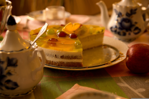 Tea Party table with coffee pot, sugar container and a cut cake.