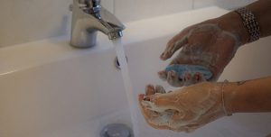 Washing hands in a sink with soap and water