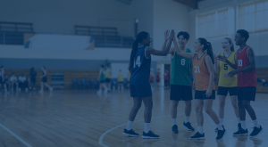 Five youth boys and girls playing basketball.